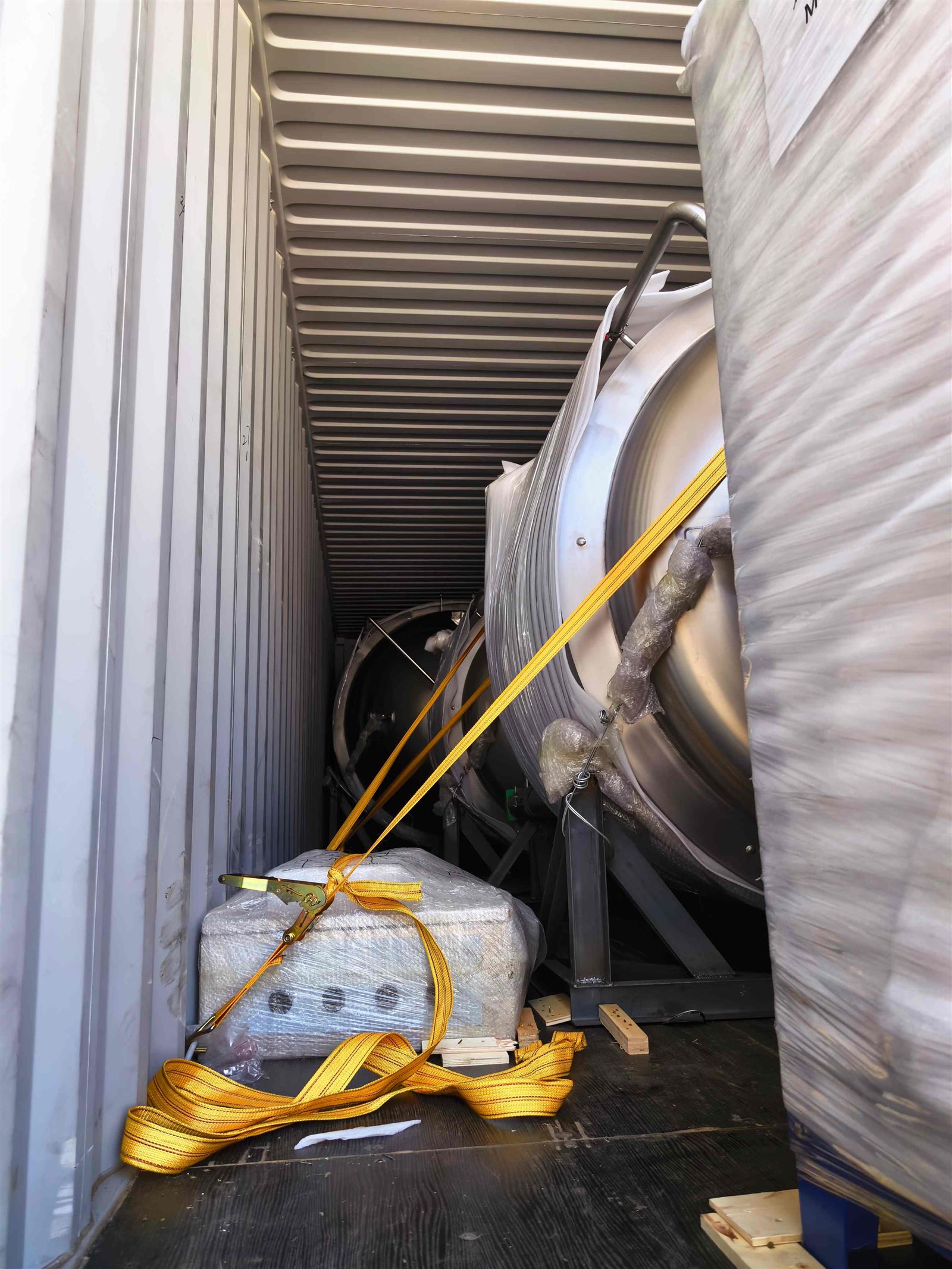 Stainless steel brewery tanks secured inside container Stainless steel brewery tanks secured inside container